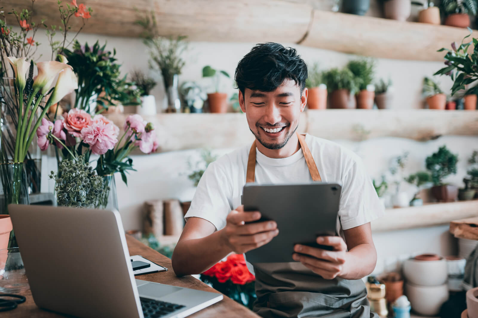 Business owner smiling at his tablet.