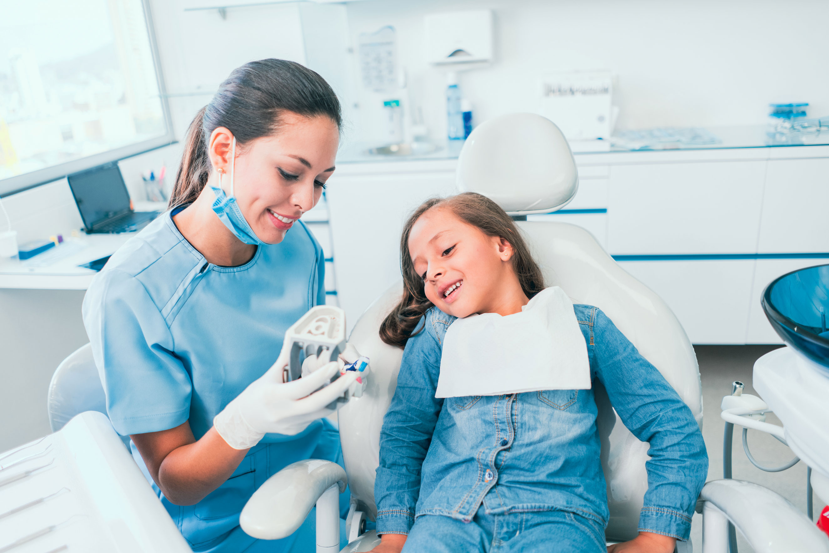 A dentist working with a young patient.