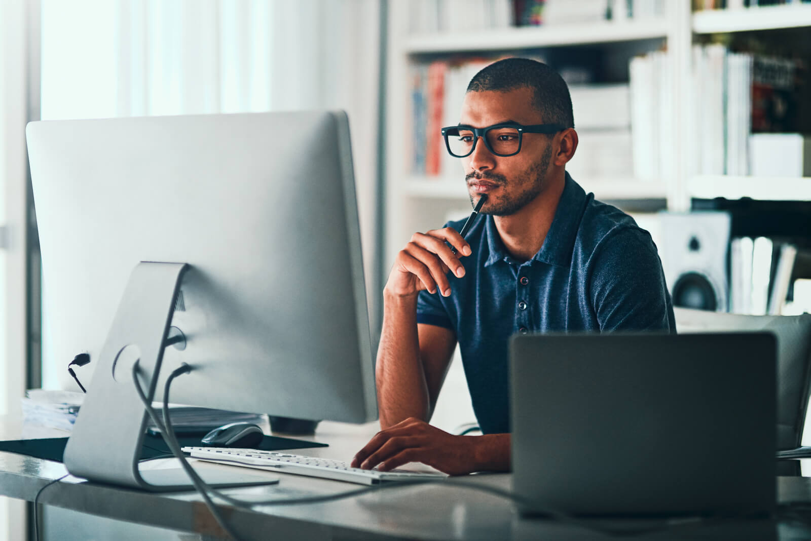 A business owner looking at his computer monitor.